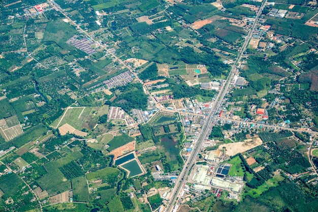 A vista do campo verde, da fazenda e da cidade no centro da tailândia. ele disparou de um avião a jato.