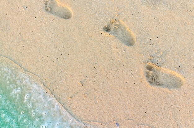 Abdrücke des Babys auf dem Sand