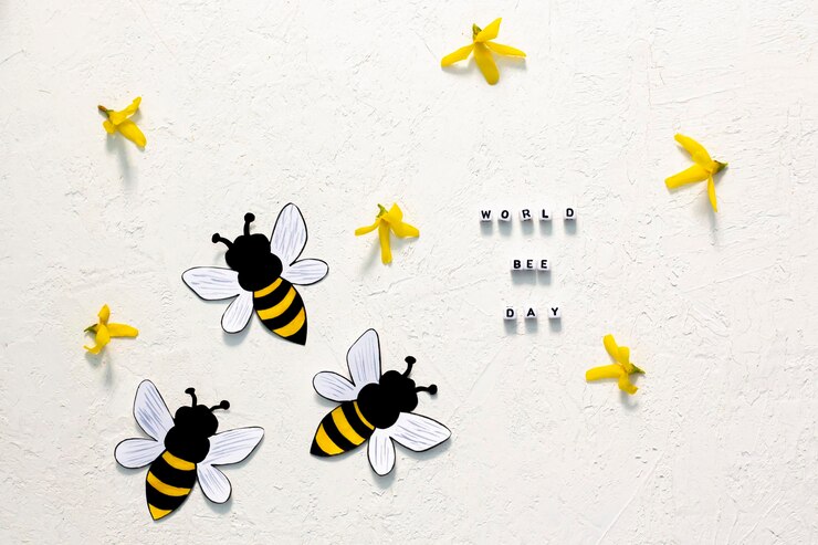 Foto abelhas artesanais com flores forsythia em fundo branco