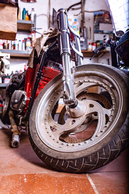 Abgeschnittene Nahaufnahme eines schönen und maßgeschneiderten Motorrads in der Werkstatt