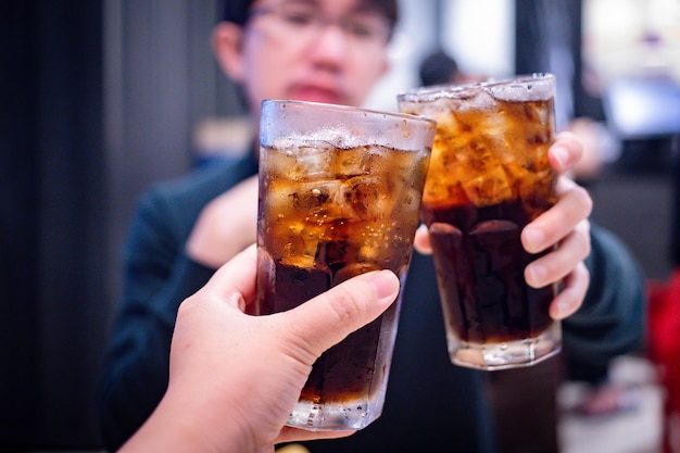 Abgeschnittenes Bild eines Bierglases, das von Hand toastet