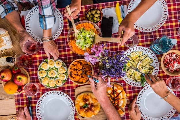 Abgeschnittenes Bild von Freunden, die zu Hause Essen essen