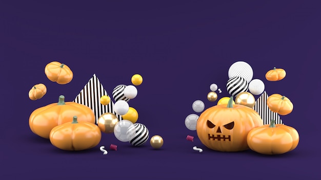 Abóbora Halloween está entre as bolas coloridas no espaço roxo