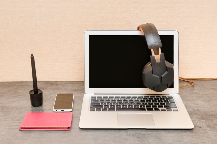 Foto abra la computadora portátil, los auriculares, el teléfono inteligente y el bloc de notas. preparación laboral