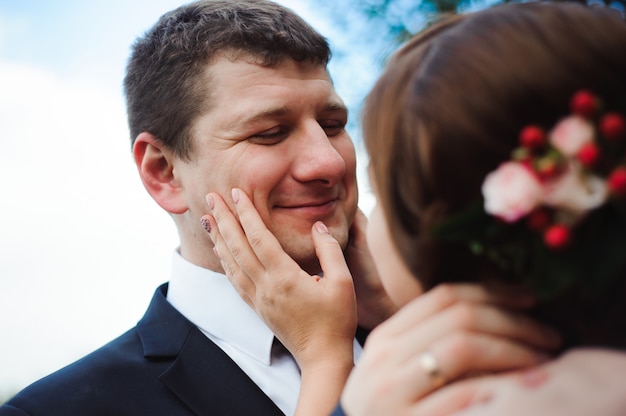 Abrazo romántico de los recién casados. Pareja camina en el parque.