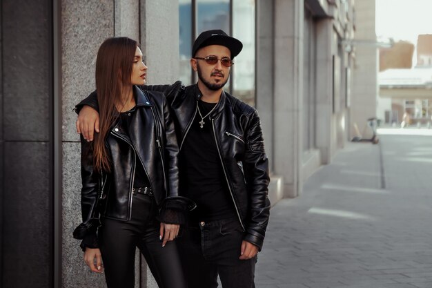 Abrazos de la joven pareja de moda en la calle