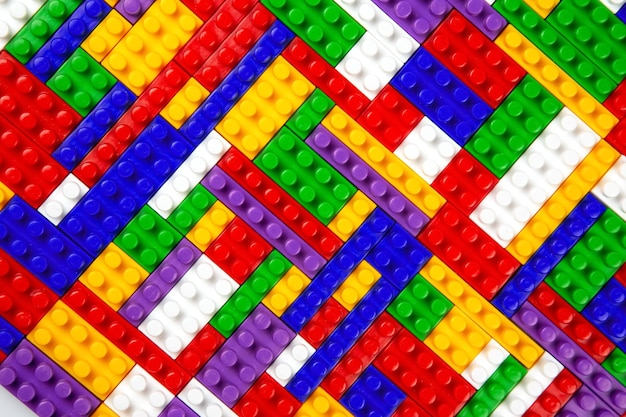 Abstrakte Hintergrundtextur von farbigen Konstruktorblöcken Hintergrund von bunten Kunststoffteilen des Konstruktors Stapel von farbigen Spielzeugziegeln