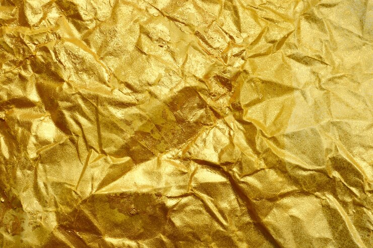 Foto abstrakter beschaffenheitshintergrund des geknitterten goldenen papiers
