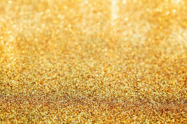 Abstrakter Goldglitterschein verschwommen mit Bokeh-Hintergrund