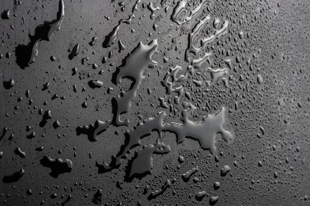 Abstrakter Hintergrund der nassen schwarzen hydrophoben Oberflächennahaufnahme mit selektivem Fokus