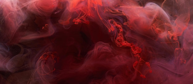 Abstrakter Hintergrund mit roter Tinte Acrylfarbe als Kulisse für Parfüm-Shisha-Kosmetik Geheimnisvolle Rauchwolken bunter Nebel
