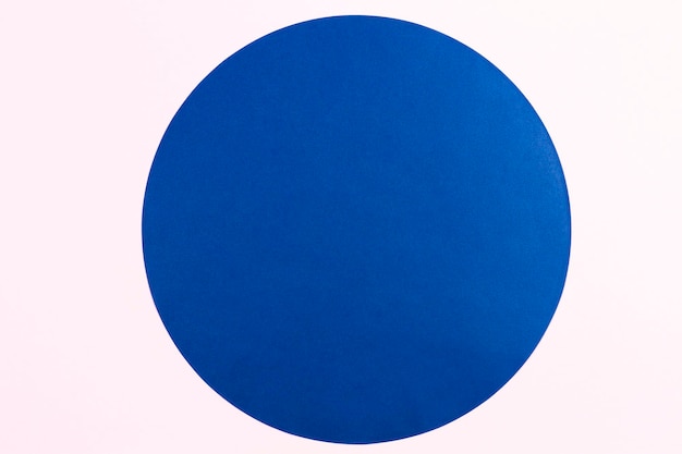 Foto abstrakter minimaler farbpapierhintergrund blauer runder kreis auf hellrosa hintergrund
