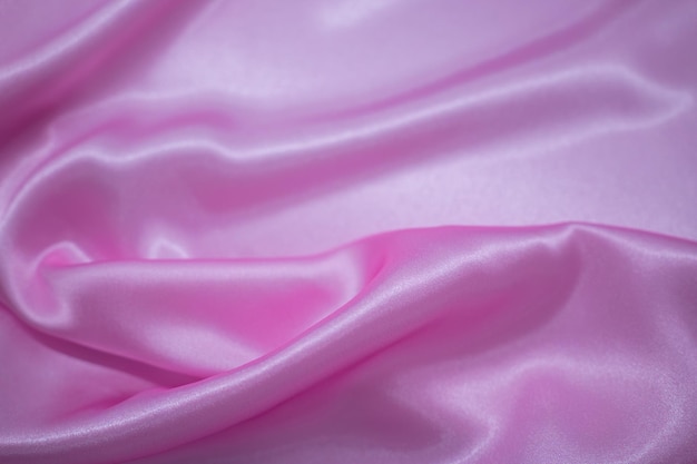 Abstrakter rosa Satin-seidiger Stoff-Textil-Drape mit Falten-Wellen-Falten-Hintergrund