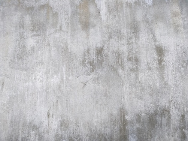 Abstrakter Texturhintergrund aus poröser, rissiger und verwitterter Zementwand