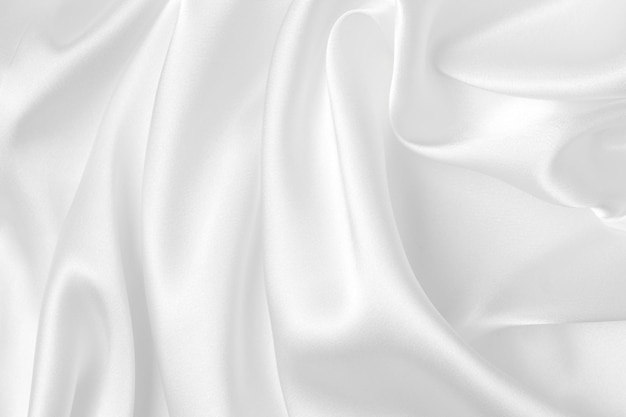 Abstrakter weißer Stoff Textur Hintergrund Tuch weiche Welle Falten aus Satinseide und Baumwolle