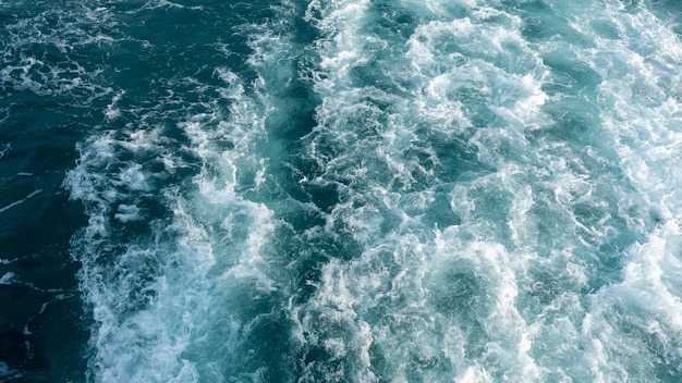 Abstraktes blaues Meerwasser mit weißer Welle für Hintergrund