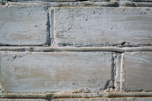 Abstrata textura resistida manchada estuque velho cinza claro e envelhecido tinta branca fundo da parede de tijolo