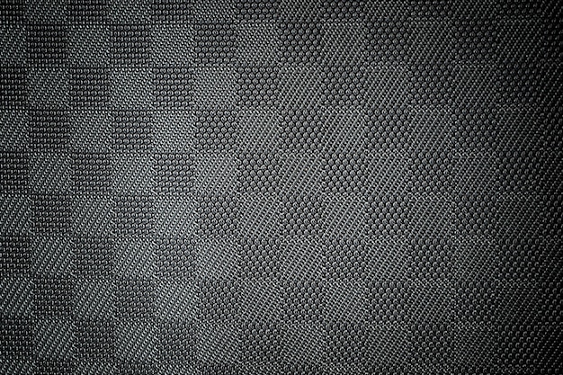 Foto abstrato decorativo com textura de fundo preto escuro com manchas e pinceladas de cinza. a textura do tecido, copie o espaço.
