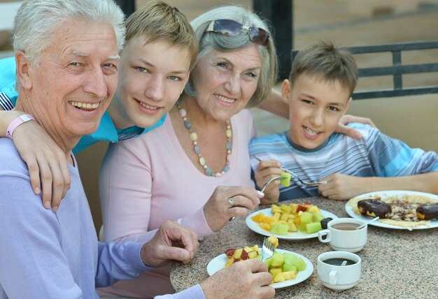 Abuelos con nietos en el desayuno en el resort tropical