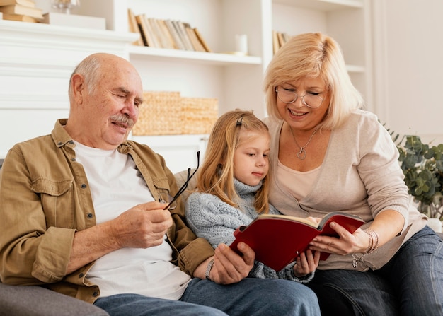 Foto abuelos de tiro medio leyendo para niños