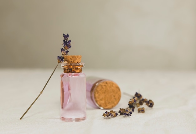 Aceite esencial de lavanda con ramo de lavanda seca