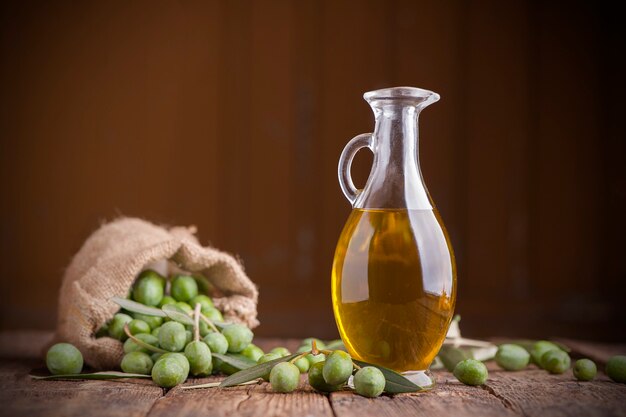 Aceite de oliva y aceitunas en mesa rústica de madera