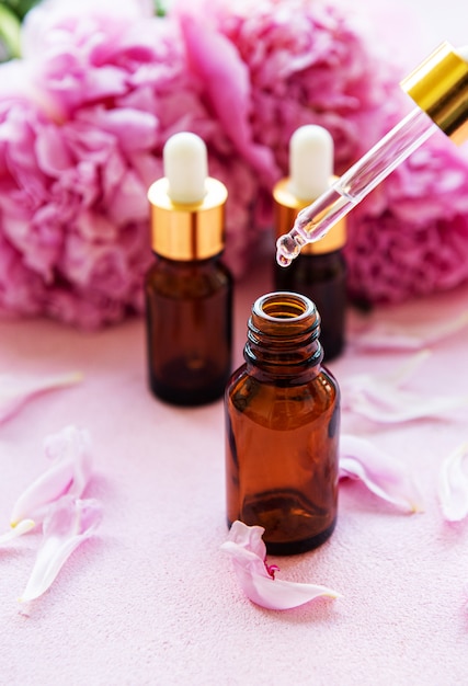 Aceites esenciales de aromaterapia y peonías rosas.