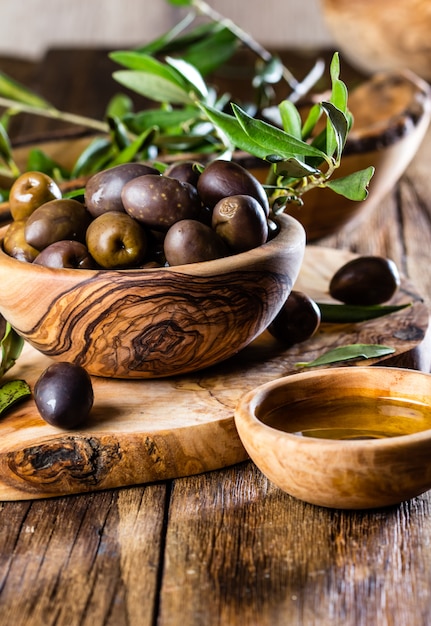 Aceitunas y aceite de oliva en cuencos de madera.