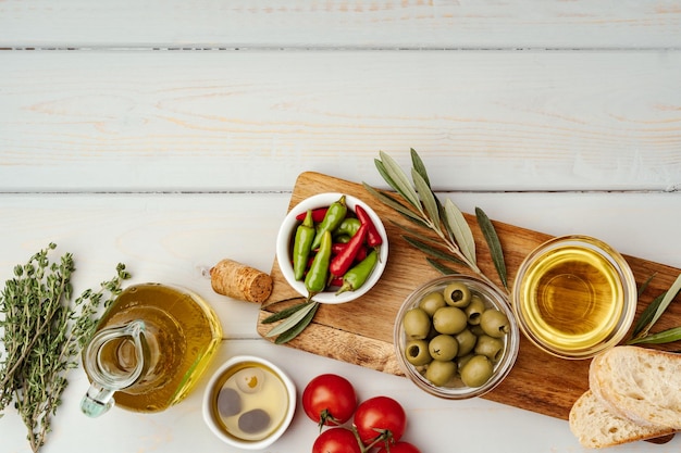 Aceitunas de aceite de oliva y tomates sobre fondo de madera