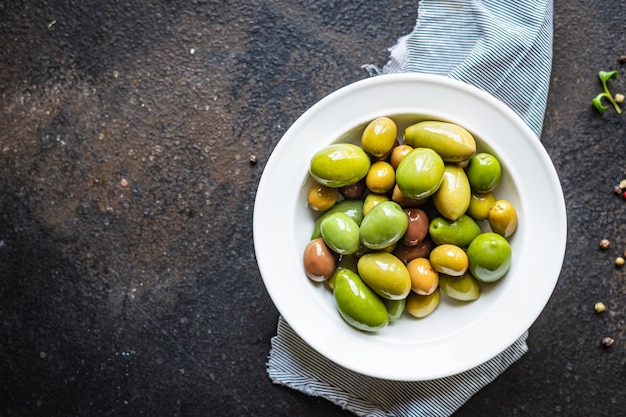 Aceitunas sin hueso en un plato sobre la mesa diferentes variedades de frutas veganas o vegetarianas