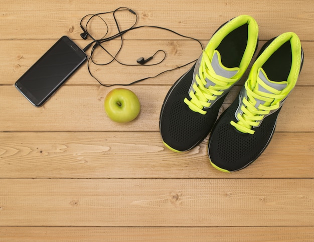 Acessórios esportivos para fitness no chão de madeira.