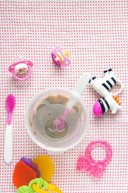 Foto acessórios para bebês em fundo de padrão rosa na mesa