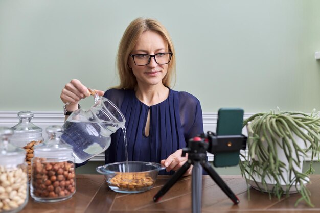 Activación de vitaminas y minerales en nueces Mujer nutricionista remojando nueces en agua