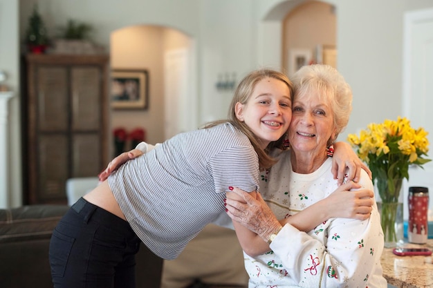 Un adolescente y una anciana abrazándose.