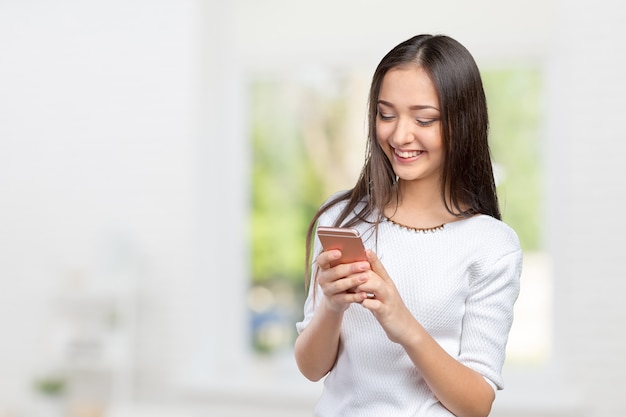 Adolescente bonita usando smartphone