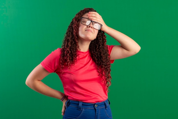 Adolescente de óculos em poses divertidas em foto de estúdio com fundo verde ideal para recorte