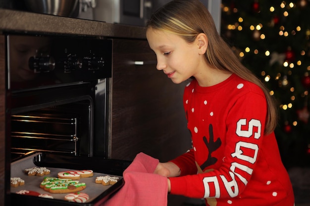 Foto adolescente fazendo biscoitos de gengibre de natal em casa