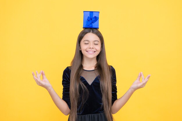 Una adolescente feliz pide un deseo por una caja de regalo en un sueño de vacaciones