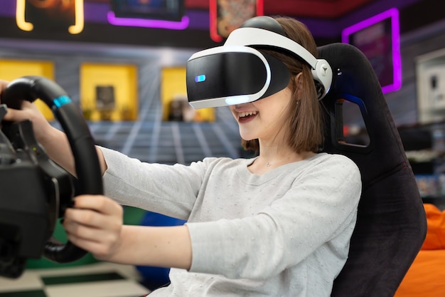 Adolescente con gafas de realidad virtual, que se aferra al volante y juega un juego de computadora en la consola