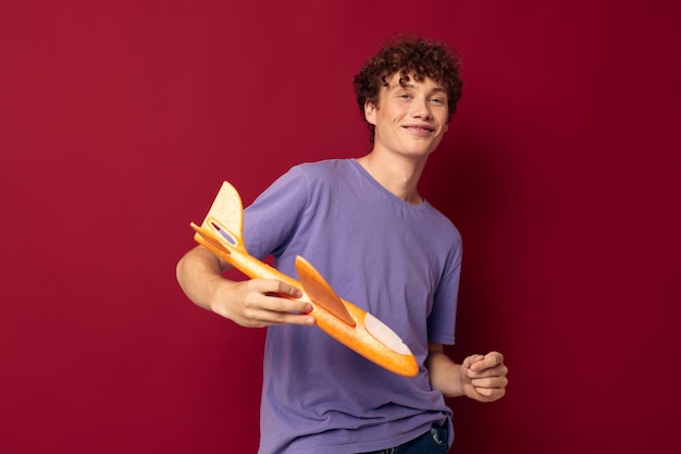 Adolescente lindo con fondo aislado de entretenimiento de avión de juguete inalterado