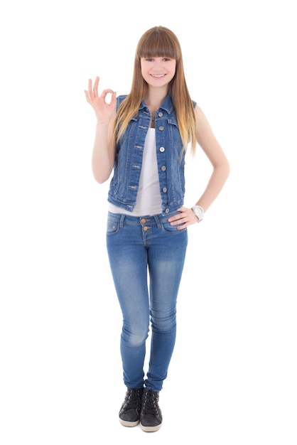 Adolescente en ropa de jeans mostrando signo ok aislado sobre fondo blanco.