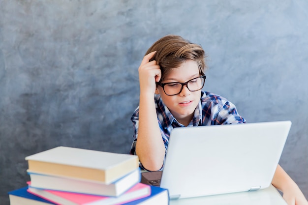 Adolescente trabajando en la computadora portátil en casa