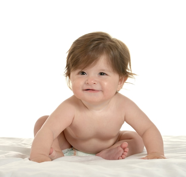 Adorable niña en una manta sobre un fondo blanco.