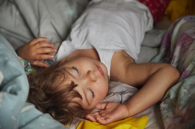 adorável bebê dormindo em um quarto escuro