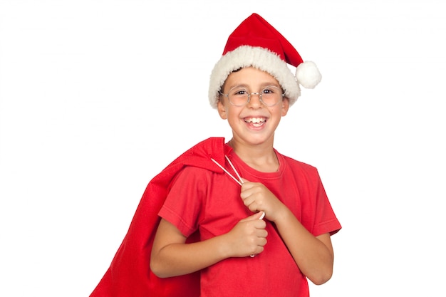 Adorável criança com chapéu de Papai Noel olhando no saco isolado no fundo branco