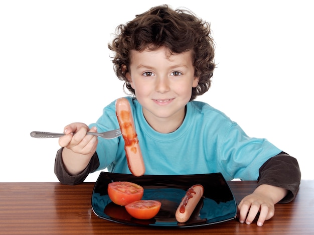 Adorável criança comendo sobre fundo branco