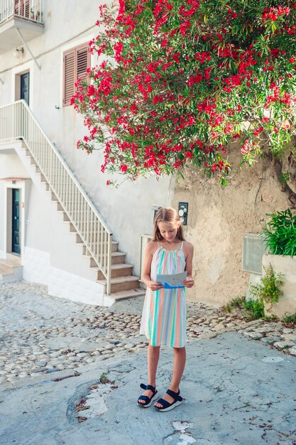 Adorável menina com mapa da cidade europeia ao ar livre