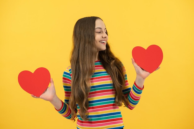 Foto adorável menina criança 12 13 14 anos com forma coração amor feriado e símbolo dos namorados dia dos namorados ou aniversário