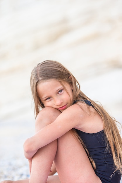 Adorável menina se divertindo na praia tropical durante as férias