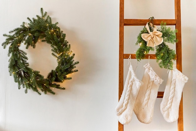 Adornos navideños festivos de una habitación luminosa con un árbol de Navidad y calcetines tejidos para los regalos de Papá Noel